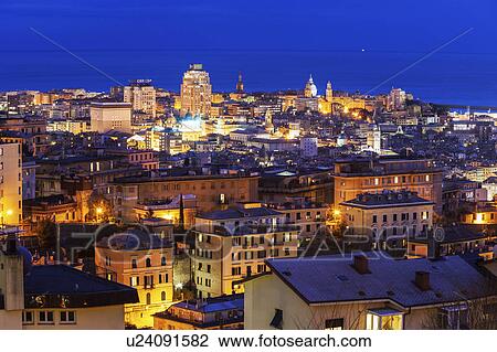 Stock Image - Cityscape with harbor in background at dusk. Fotosearch