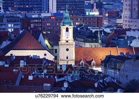 Clock tower among buildings View Large Photo Image Picture - Clock tower among buildings. Fotosearch