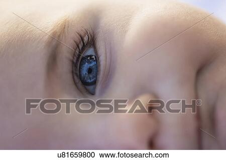Stock Image - Close-of baby boy's (6-11 months) blue eye. Fotosearch