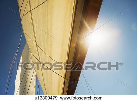 Close-up of sun shining through boat's sail View Large Photo Image Stock Photo - Close-up of sun shining through boat's sail. Fotosearch