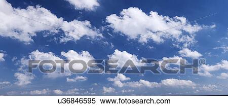 Stock Photography - Clouds against blue sky. Fotosearch