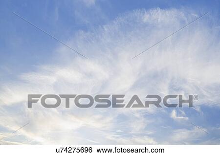 Stock Photograph - Clouds on blue sky. Fotosearch