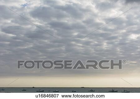 Cloudscape above sea with boats View Large Photo Image Stock Photo - Cloudscape above sea with boats. Fotosearch