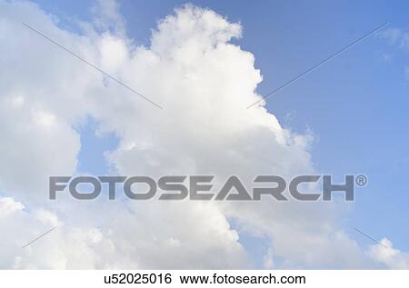 Stock Photograph - Cumulus cloud on blue sky. Fotosearch