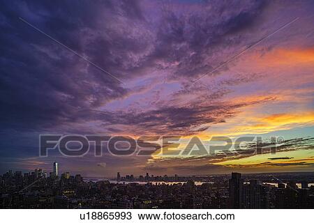 Dramatic sky over city at sunset View Large Photo Image Stock Image - Dramatic sky over city at sunset. Fotosearch