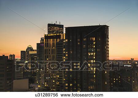 Stock Photograph - Dusk lights over cityscape. Fotosearch