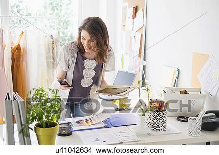 Picture - Female fashion designer in her office. Fotosearch