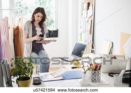 Picture - Female fashion designer in her office. Fotosearch