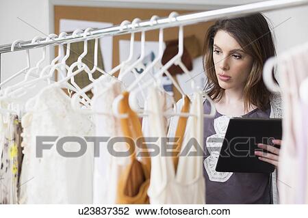 Stock Image - Female fashion designer in her office. Fotosearch