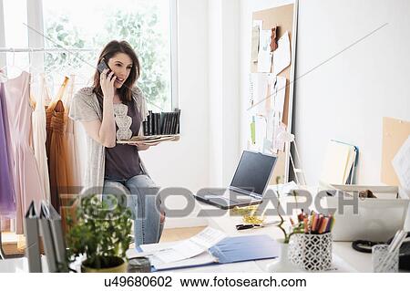 Female fashion designer in her office View Large Photo Image Stock Image - Female fashion designer in her office. Fotosearch