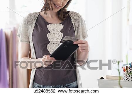 Female fashion designer in her office View Large Photo Image Stock Image - Female fashion designer in her office. Fotosearch