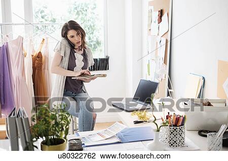 Stock Image - Female fashion designer in her office. Fotosearch