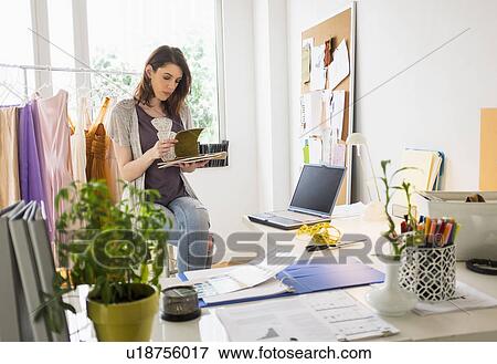 Stock Photo - Female fashion designer in her office. Fotosearch