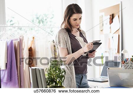 Stock Photograph - Female fashion designer in her office. Fotosearch