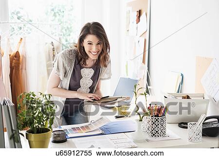 Stock Photography - Female fashion designer in her office. Fotosearch