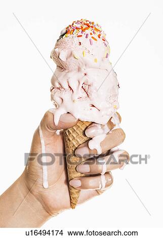 Picture - Female hand holding ice cream. Fotosearch