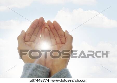 Female hands against clouds, sun shining through fingers View Large Photo Image Picture - Female hands against clouds, sun shining through fingers. Fotosearch