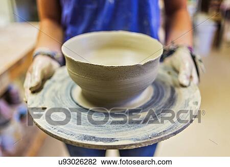 female potter holding clay bowl View Large Photo Image Stock Image - female potter holding clay bowl. Fotosearch