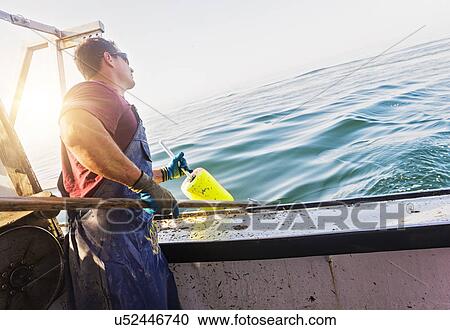 Fisherman throwing lobster buoy View Large Photo Image Stock Image - Fisherman throwing lobster buoy. Fotosearch