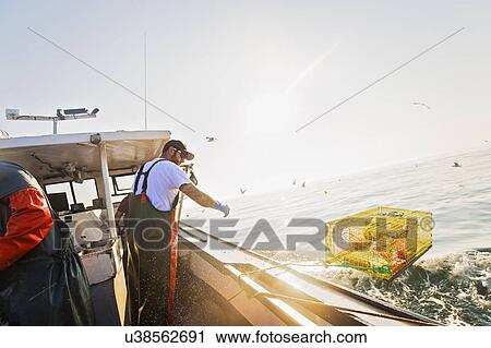 Fisherman working on fishing boat View Large Photo Image Stock Image - Fisherman working on fishing boat. Fotosearch