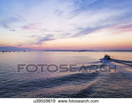 Stock Photo - Fishing boat heading towards harbor. Fotosearch