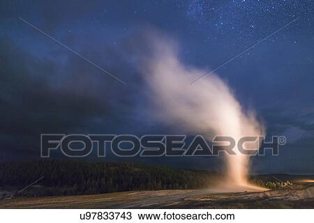 Stock Image - Geyser erupting at night. Fotosearch