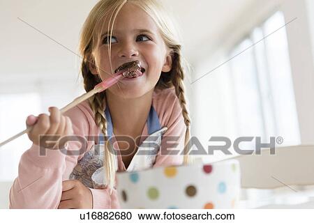Girl (6-7) eating chocolate View Large Photo Image Stock Image - Girl (6-7) eating chocolate. Fotosearch