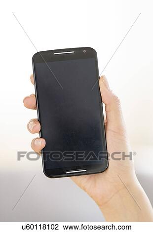 Hand holding smart phone View Large Photo Image Stock Image - Hand holding smart phone. Fotosearch