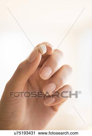 Hand holding vitamin pill View Large Photo Image Stock Image - Hand holding vitamin pill. Fotosearch