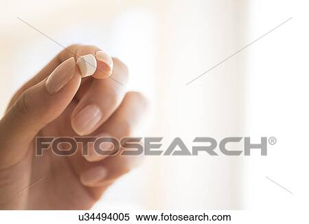 Hand holding vitamin pill View Large Photo Image Stock Photography - Hand holding vitamin pill. Fotosearch