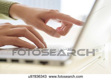 Hand typing at laptop View Large Photo Image Stock Image - Hand typing at laptop. Fotosearch