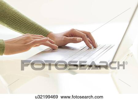 Stock Photo - Hands typing on laptop keyboard. Fotosearch