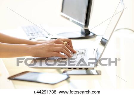Hands typing on laptop keyboard View Large Photo Image Stock Photo - Hands typing on laptop keyboard. Fotosearch