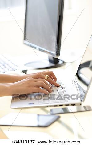 Hands typing on laptop keyboard View Large Photo Image Stock Photo - Hands typing on laptop keyboard. Fotosearch