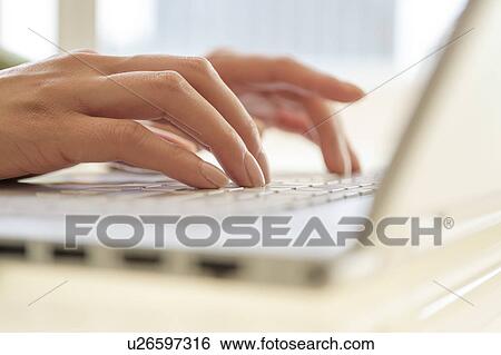 Hands typing on laptop keyboard View Large Photo Image Stock Photograph - Hands typing on laptop keyboard. Fotosearch