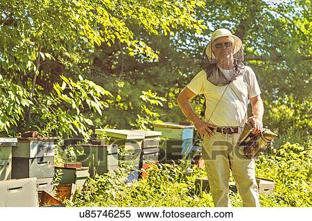 Stock Photography - Hope, Portrait of beekeeper in protective mask. Fotosearch