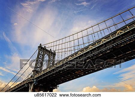 Stock Image - Hudson River, Brooklyn Bridge against sky. Fotosearch