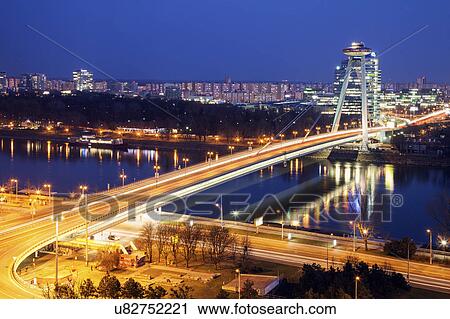 Illuminated bridge over river at night View Large Photo Image Stock Image - Illuminated bridge over river at night. Fotosearch
