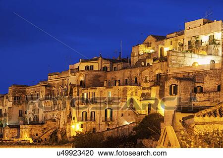 Illuminated city buildings at dusk View Large Photo Image Stock Image - Illuminated city buildings at dusk. Fotosearch
