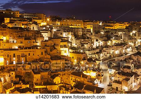 Illuminated city buildings at night View Large Photo Image Stock Image - Illuminated city buildings at night. Fotosearch