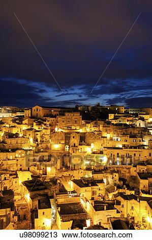 Illuminated city buildings at night View Large Photo Image Stock Image - Illuminated city buildings at night. Fotosearch