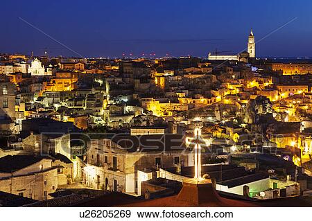 Stock Photo - Illuminated city buildings at night. Fotosearch