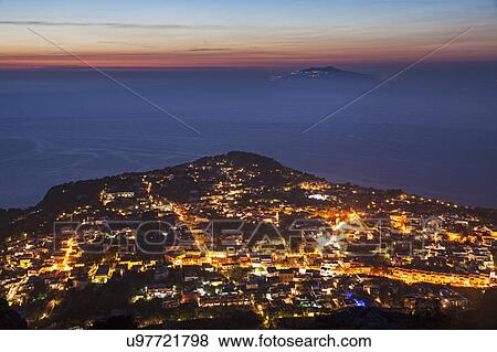 Stock Photo - Illuminated cityscape at dusk. Fotosearch