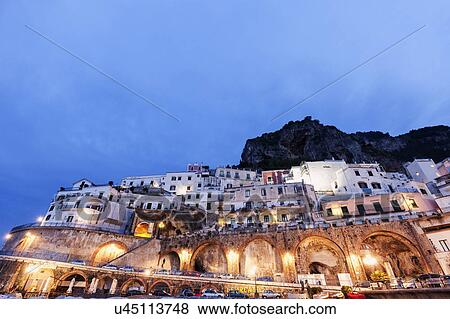 Stock Photo - Illuminated town at dusk. Fotosearch