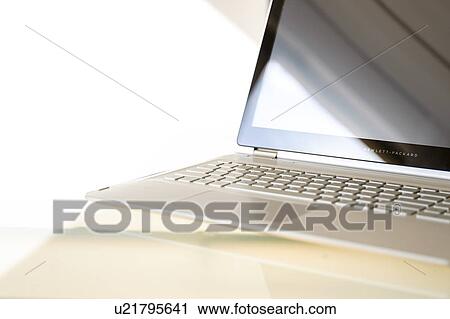 Stock Image - Laptop on glass table. Fotosearch