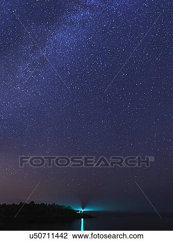 Stock Image - Lighthouse at night. Fotosearch