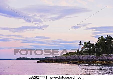 Stock Image - Lighthouse at sunset. Fotosearch