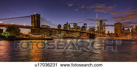 Stock Image - Lower Brooklyn Bridge at sunset. Fotosearch