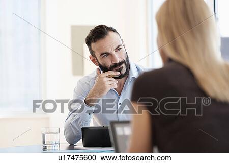 Man and woman sitting in office View Large Photo Image Stock Image - Man and woman sitting in office. Fotosearch