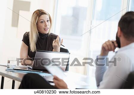 Man and woman talking in office View Large Photo Image Stock Image - Man and woman talking in office. Fotosearch